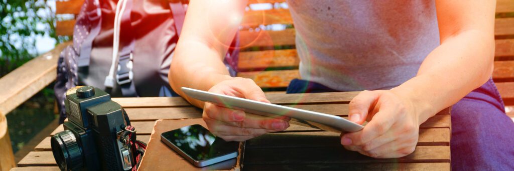 A person holding an ipad and looking at the screen.